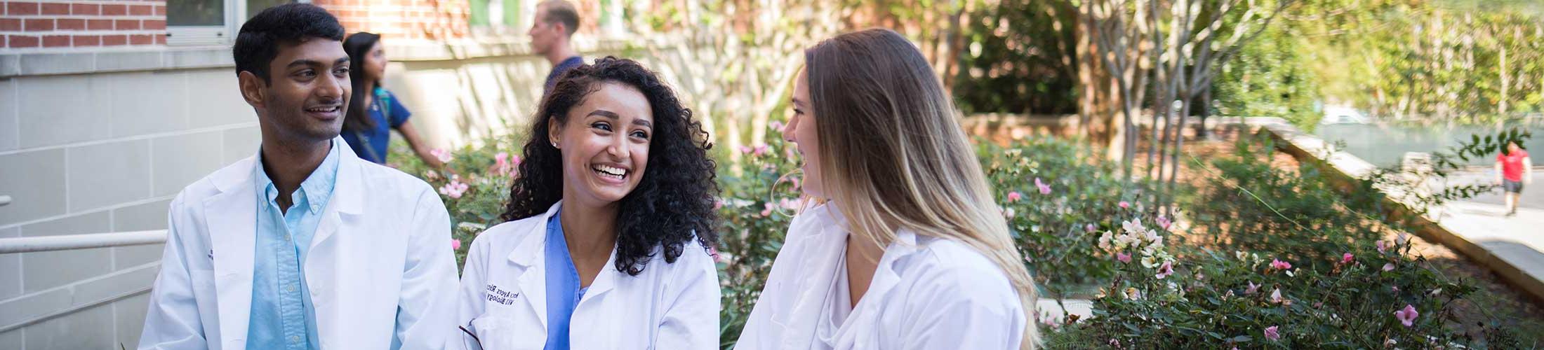 Biomedical students students walking outside of the Allied Health building.